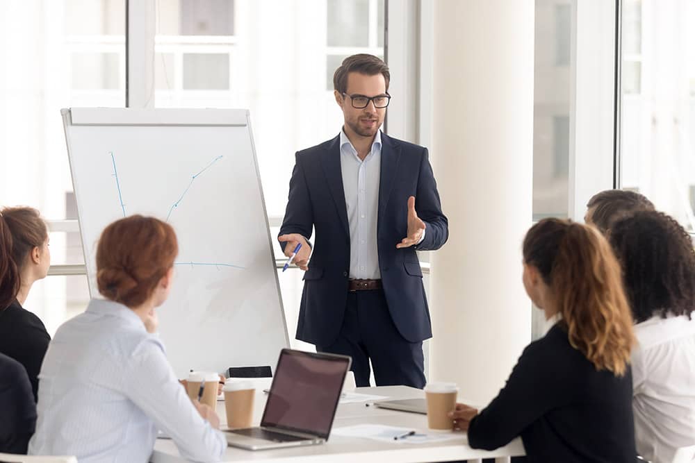 Male business coach speaker in suit give flipchart presentation